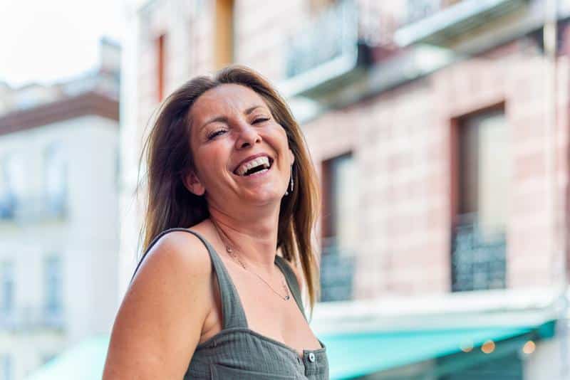 a woman laughing and feeling relieved from heavy periods after undergoing novasure endometrial ablation in fort myers and naples, fl