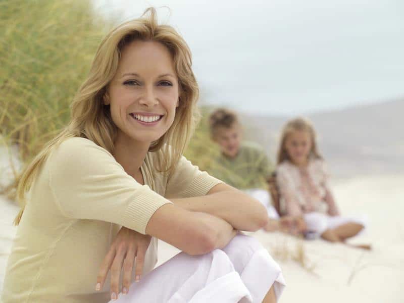 woman-smiling-at-naples-beach-after-perineoplasty-in-fort-myers woman smiling at Naples beach after perineoplasty surgery in Fort Myers, FL